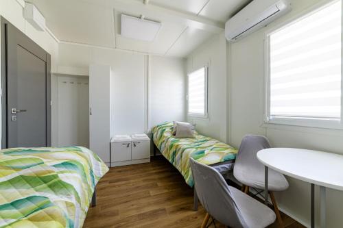 a room with two beds and a table at TASKAN Noclegi in Okmiany