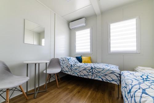 a bedroom with a bed and a table and chairs at TASKAN Noclegi in Okmiany
