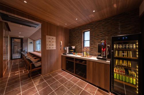 a bar in a restaurant with a counter and some drinks at Ryotei Matsubaya in Beppu