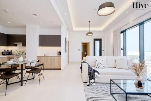 a living room with a white couch and a table at 7 By Aurora 310 in Dubai