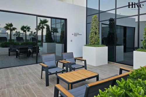 a patio with chairs and tables in a building at 7 By Aurora 310 in Dubai