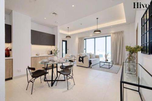 a kitchen and living room with a table and chairs at 7 By Aurora 310 in Dubai