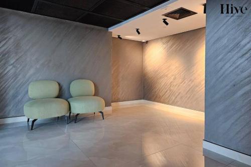 two chairs sitting next to each other in a room at 7 By Aurora 310 in Dubai