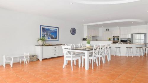 a kitchen and dining room with a table and chairs at Villa Provence - Stunning Views, Walk to resorts. 5 Bed 3 Bath in Coffs Harbour