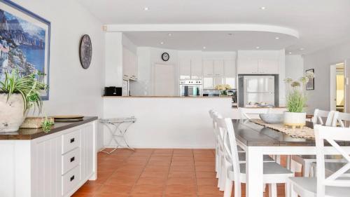 a kitchen and dining room with a table and chairs at Villa Provence - Stunning Views, Walk to resorts. 5 Bed 3 Bath in Coffs Harbour
