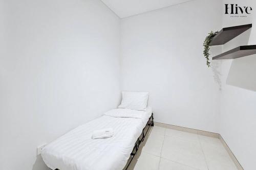 a bed in a room with a white wall at 7 by Aurora 207 in Dubai