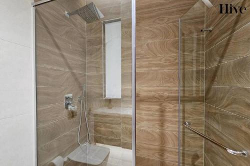 a shower with a glass door in a bathroom at 7 by Aurora 207 in Dubai