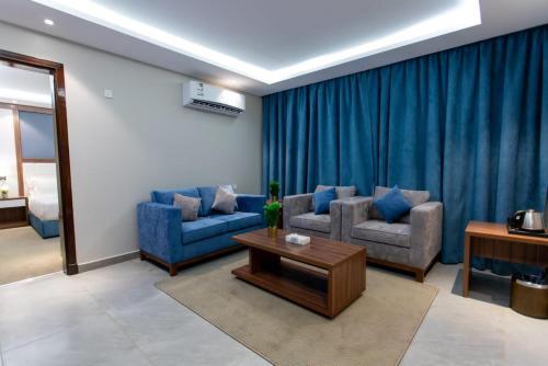 a living room with two chairs and a table at منتجع حياة ريزيدنس in Abha
