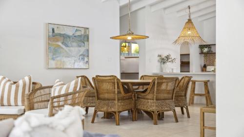 a dining room with a table and chairs at Sojourn - Pool Oasis, Designer Home, opp Beach in Emerald Beach