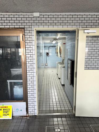 an open door to a bathroom in a building at エルザビル402 in Sumiyoshi
