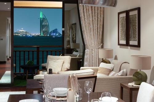 a living room with a view of the city at Luxury Apartments in Anantara Resort with Stunning Burj AlArab & Sea Views in Dubai