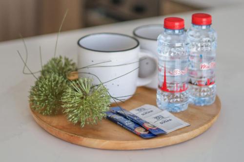 a wooden tray with bottles of water and plants at 7 By Aurora 102 Jebel Ali in Dubai