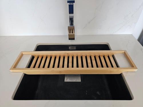 a wooden bench sitting on top of a sink at 7 By Aurora 102 Jebel Ali in Dubai