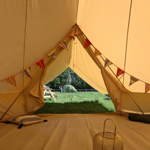 a close up of a tent with a field in the background at Fallow Fields Camping, Selson Farm in Eastry