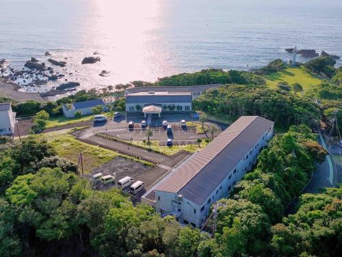 an aerial view of a building next to the ocean at Hotel Holistic Resort Wakayama in Taiji