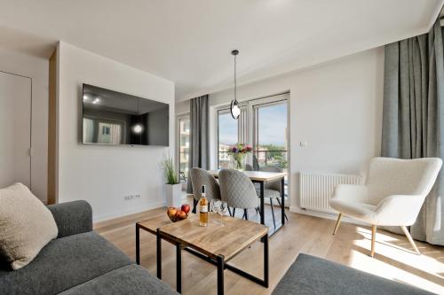a living room with a couch and a table at Casa Baia BlueApart Hel in Hel