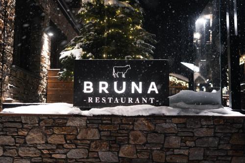 a sign in front of a building with a christmas tree at Serras Andorra in Soldeu