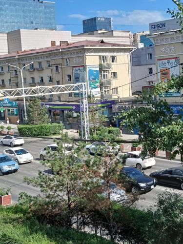 a parking lot with cars parked in front of buildings at Lana Hostel in Ulaanbaatar