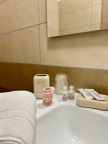 a bathroom sink with towels and other items on it at Dimora T'ama in San Lorenzello