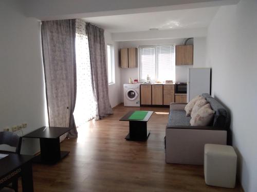 a living room with a couch and a kitchen at Апартаменты за гости Гаван in Byala