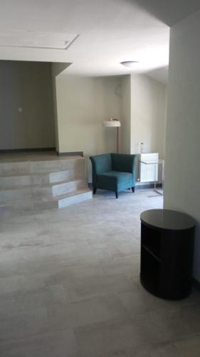 a living room with a blue couch and a table at EdMont in Pietroşiţa