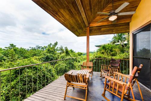 a porch with chairs and a ceiling fan at Boutique Hotel Luna Azul in Playa Ostional
