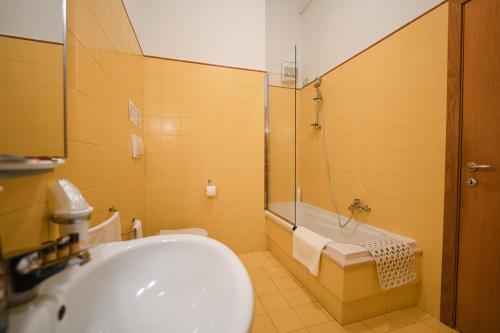 a bathroom with a tub and a toilet and a sink at La Piccola Torre in Bisceglie