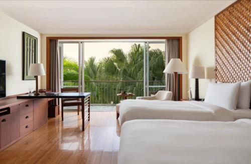 a hotel room with two beds and a balcony at Mandarin Oriental, Sanya in Sanya