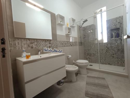 a bathroom with a toilet and a sink and a shower at Da Nonna Melina by Holiday World in Licata