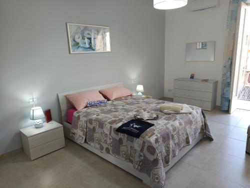 a bedroom with a bed with a blanket on it at Da Nonna Melina by Holiday World in Licata