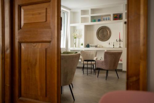 a dining room with chairs and a table in a room at La Casetta di Ceci in Vibonati