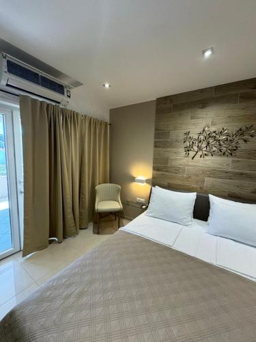 a bedroom with a large bed with a wooden wall at Guest house Kokolo in Hvar