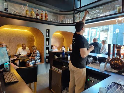 a man standing at a bar in a restaurant at WOT Porto in Porto