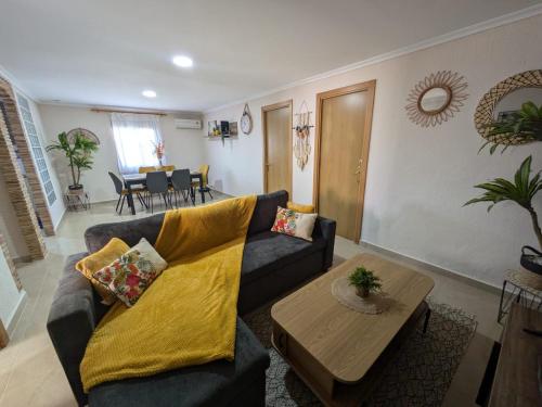 a living room with a couch and a table at Buen Estar, piscina, barbacoa, jacuzzi en Valencia in Turís