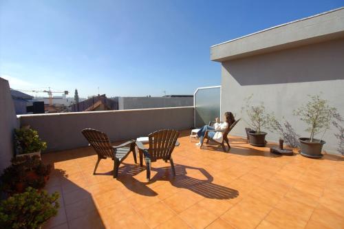 a woman sitting in a chair on a balcony at WOT Porto in Porto
