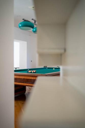 a pool table in a living room with a pool at La Casetta di Ceci in Vibonati