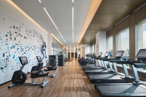a gym with a row of cardio machines at Sheraton Shanghai Pudong Riverside in Shanghai