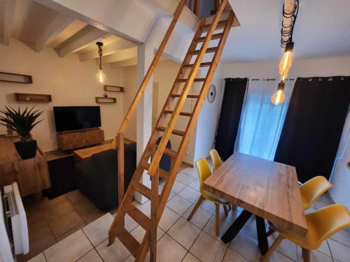 a wooden ladder in a living room with a wooden table at Logement entier dans propriété in Saint-Michel-sous-Bois