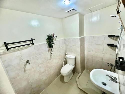 a bathroom with a toilet and a sink at Seawind 3Bedroom in Davao City