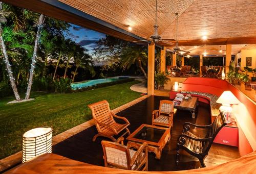 a patio with chairs and a table and a pool at Boutique Hotel Luna Azul in Playa Ostional