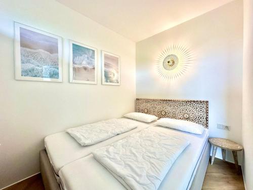 a bedroom with two beds and a mirror on the wall at FeWo Traumblick - Himmel & Meer mit TRAUM Meerblick am Strand mit großem Balkon - WLAN, Streaming, 2024 modernisiert in Sierksdorf