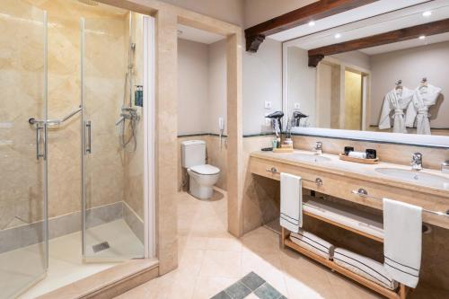 a bathroom with a shower and a sink and a toilet at Melia Villaitana in Benidorm