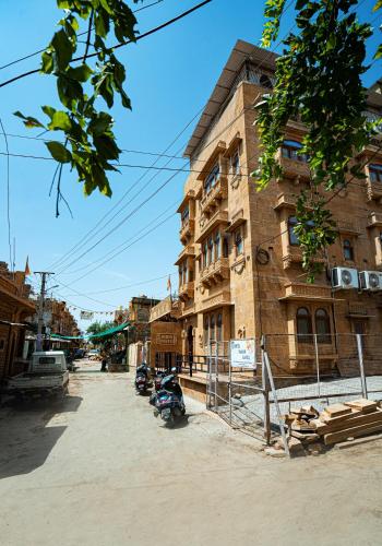 a building with a motorcycle parked in front of it at Naman Haveli-Boutique Stay For Budget Travllers in Jaisalmer
