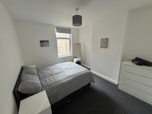 a bedroom with a bed and a window at Theo apartment 150 meters from the winter gardens large groups welcome in Blackpool