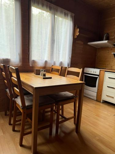 a wooden table and chairs in a kitchen at Chata Čertovy hlavy in Želízy