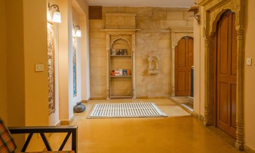 a hallway with a door and a rug on the floor at Naman Haveli-Boutique Stay For Budget Travllers in Jaisalmer