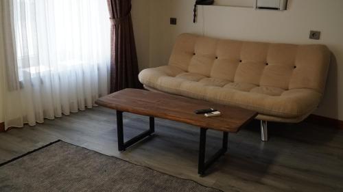 a living room with a couch and a coffee table at Pikan Ephesus in Selcuk
