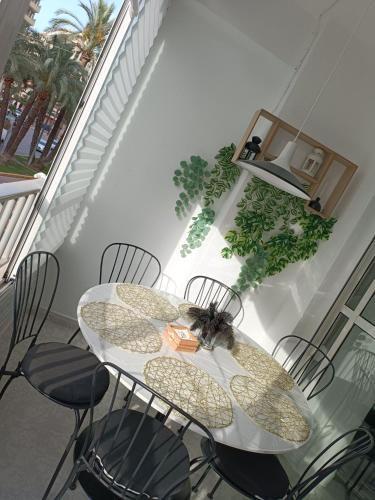 a table with chairs and a bee sitting on it at Amazing beach apartment in Cullera