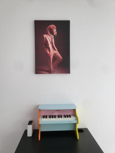 a painting of a woman standing next to a piano at Rigi Paradise in Vitznau, Lake access, Ferry Terminal, Rigibahn, Restaurants all 2 minutes walking distance in Vitznau