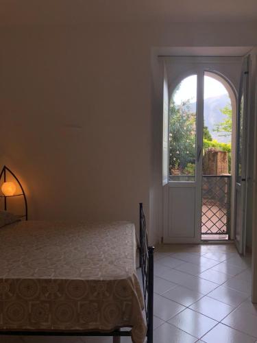 a bedroom with a bed and an open door at Appartamenti Miravalle in Maratea